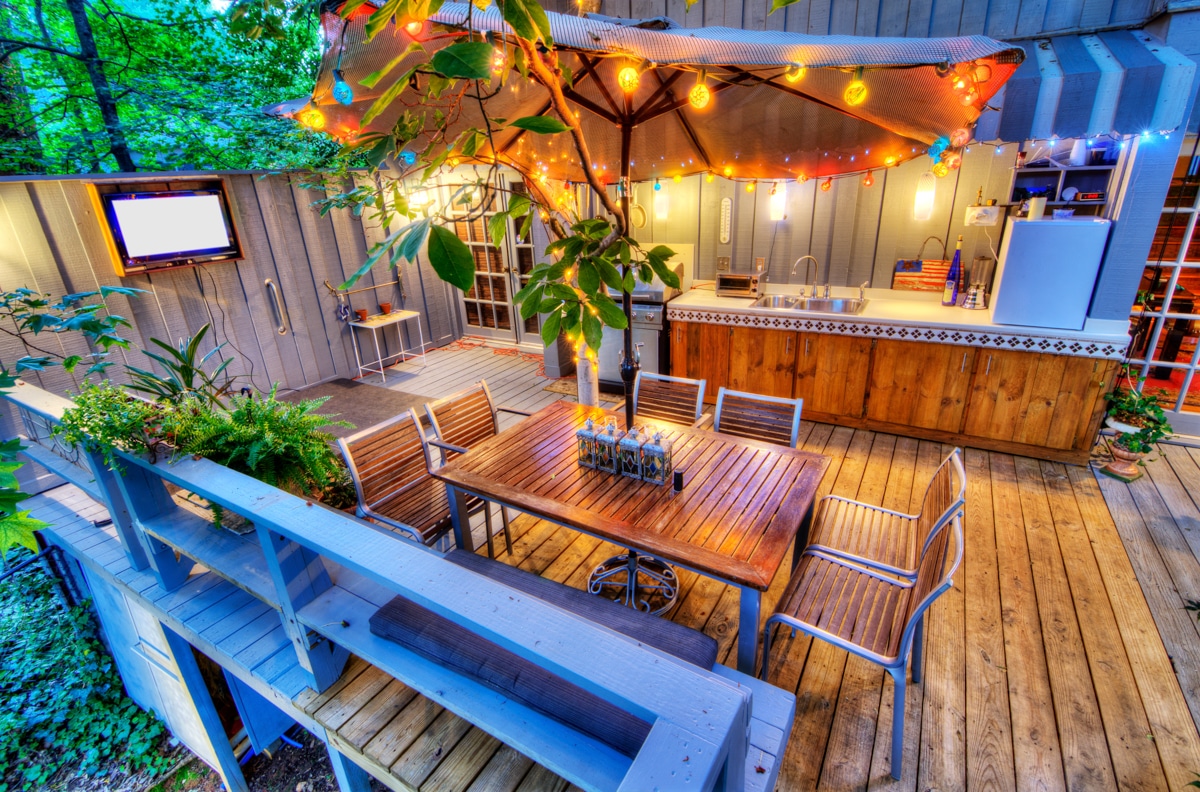 Outdoor patio with bar, grill, and dining table