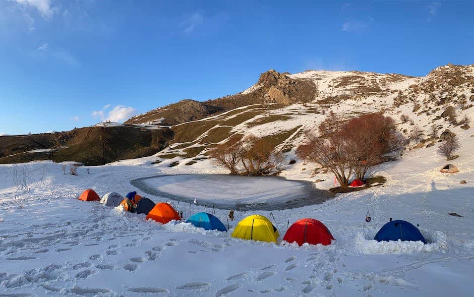 A group of winter camping tents in a snowy landscape